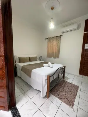 a bedroom with a bed with a table in it at Riad Zou Palm in Marrakech