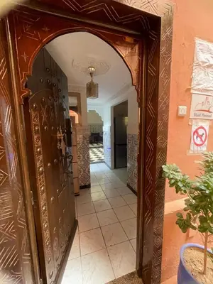 an entrance to a room with a large wooden door at Riad Zou Palm in Marrakech
