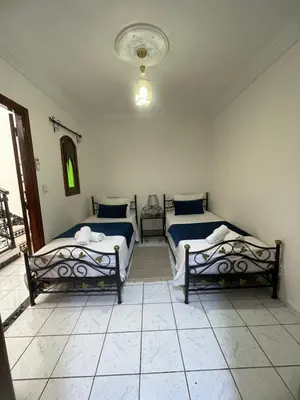 a bedroom with two beds in a room at Riad Zou Palm in Marrakech