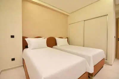 two beds sitting next to each other in a room at Le Petit Medina - 4prs - Wifi - Semlalia in Marrakech