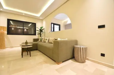 a living room with a couch and a table at Le Petit Medina - 4prs - Wifi - Semlalia in Marrakech