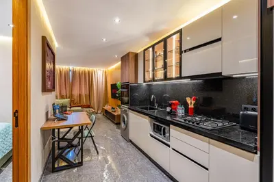 a kitchen with white cabinets and a counter top at Le Grand Jazzy in Marrakech