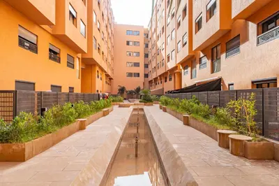 a row of benches in a courtyard of a building at Le Grand Jazzy in Marrakech
