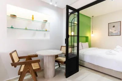 a bedroom with a bed and a table and a desk at Le Parisien Modern Studio in Hivernage in Marrakech