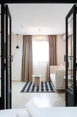 a living room with a couch and a table at Le Parisien Modern Studio in Hivernage in Marrakech