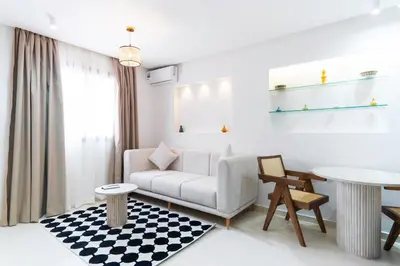 a living room with a couch and a table at Le Parisien Modern Studio in Hivernage in Marrakech