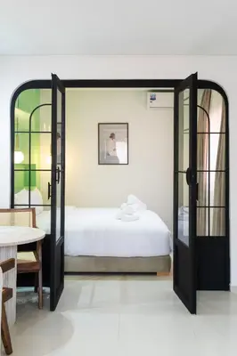 a bedroom with a bed and a large mirror at Le Parisien Modern Studio in Hivernage in Marrakech