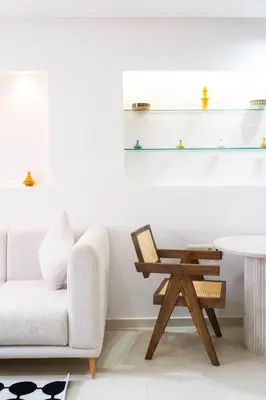 a living room with a chair and a table at Le Parisien Modern Studio in Hivernage in Marrakech