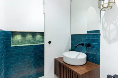 a bathroom with a white sink and blue tiles at Studio Horizon Marrakech Station in Marrakech