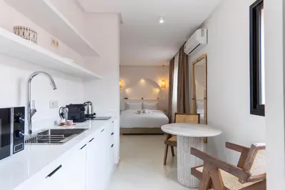 a kitchen with a table and a bed in a room at Studio Horizon Marrakech Station in Marrakech