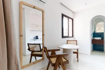 a mirror in a room with a table and chairs at Studio Horizon Marrakech Station in Marrakech