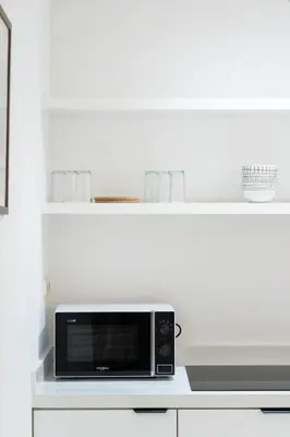 a microwave sitting on top of a white counter at Studio Horizon Marrakech Station in Marrakech