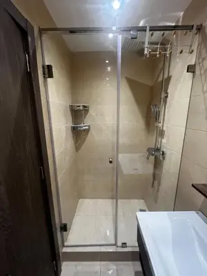 a shower with a glass door in a bathroom at L'Oasis Des Amis in Marrakech