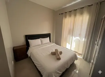a teddy bear sitting on a bed in a bedroom at RS 13 by KMREI Properties in Marrakech