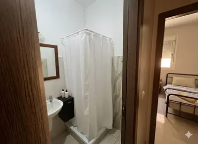 a bathroom with a white shower curtain and a sink at RS 13 by KMREI Properties in Marrakech