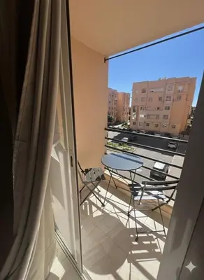 a balcony with a table and chairs and a window at RS 13 by KMREI Properties in Marrakech