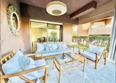a living room with couches and a table at Fabuleux T4 110 m2 prestigia Luxury in Marrakech
