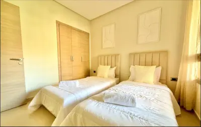 two beds sitting next to each other in a bedroom at Fabuleux T4 110 m2 prestigia Luxury in Marrakech