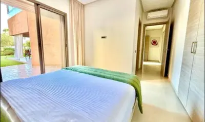 a bed in a room with a large window at Fabuleux T4 110 m2 prestigia Luxury in Marrakech