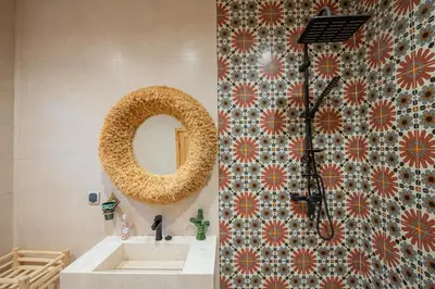 a bathroom with a sink and a mirror at Riad Timitar in Marrakech