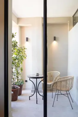 a patio with a table and chairs and plants at Majorelle Modern A Unique Green Cocoon in Marrakech
