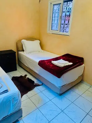 a bedroom with a bed and a window on the floor at Lina Stay Riad Alkaria Assiyahia in Marrakech