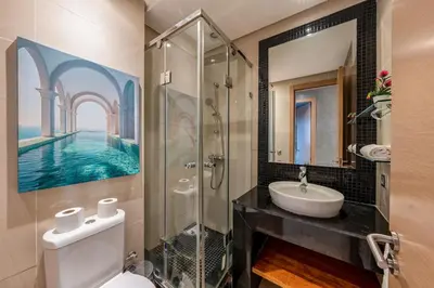 a bathroom with a sink toilet and a mirror at Cozy Apt with pool, Wifi, parking, Golf Views & Sunny Private Balcony in Marrakech