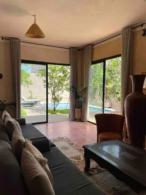 a living room with a couch and a table at Villa privée in Marrakech