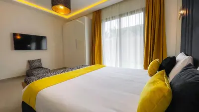 a bedroom with a large bed and a window at Beautiful Villa Agathe with heated pool in Marrakech