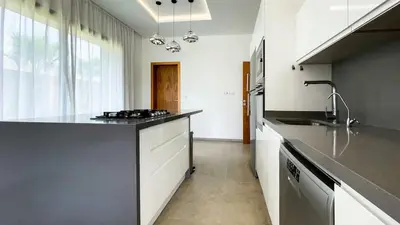 a kitchen with a sink and a counter top at Syrine Villa with temperate pool, not overlooked in Marrakech