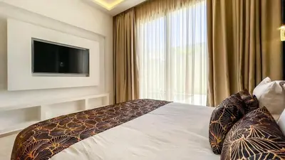a bedroom with a bed with a flat screen tv at Beautiful Stella villa with heated pool, Marrakech in Marrakech