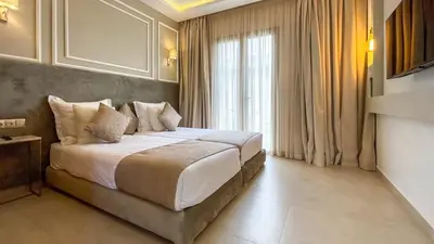 a bedroom with a bed and a large window at Beautiful Stella villa with heated pool, Marrakech in Marrakech