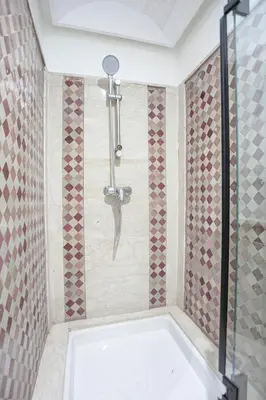 a shower with a shower head in a bathroom at The Good Mood - Hivernage Marrakech in Marrakech