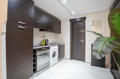 a kitchen with a washer and a washing machine at The Good Mood - Hivernage Marrakech in Marrakech