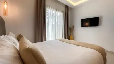 a bedroom with a white bed and a window at Beautiful Bianca villa with heated pool in Marrakech