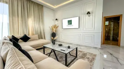 a living room with a couch and a table at Superbe Villa Alma piscine chauffée à Marrakech in Marrakech