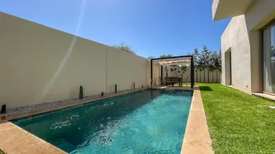 a swimming pool in the backyard of a house at Superbe Villa Alma piscine chauffée à Marrakech in Marrakech