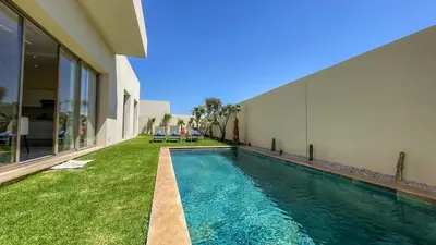 a swimming pool in the backyard of a house at Superbe Villa Alma piscine chauffée à Marrakech in Marrakech
