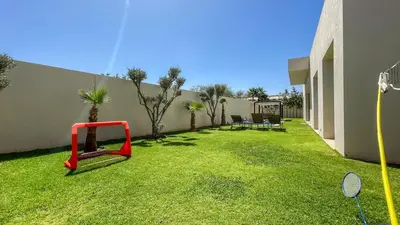 a yard with a swing in a house at Superbe Villa Alma piscine chauffée à Marrakech in Marrakech