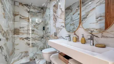 a bathroom with a toilet and a sink and a mirror at Villa Amélia pool without opposite in Marrakech