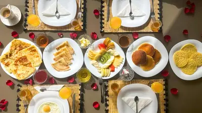 a table full of plates of food on a table at Villa Amélia pool without opposite in Marrakech