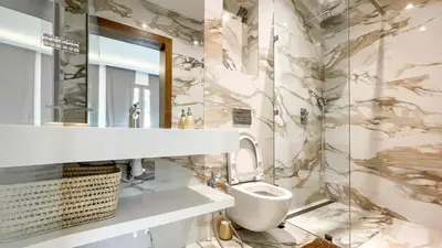 a bathroom with a sink and a toilet and a mirror at Villa Amélia pool without opposite in Marrakech