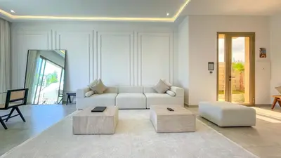a living room with a white couch and a table at Villa Eden in Marrakech