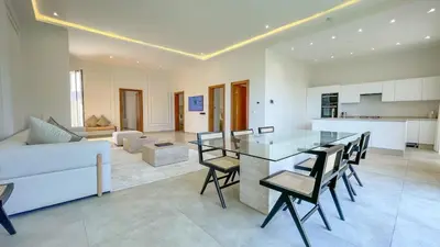 a kitchen and living room with a table and chairs at Villa Eden in Marrakech