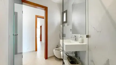 a bathroom with a toilet and a sink and a mirror at Beautiful Bahia villa with heated pool in Marrakesh in Marrakech