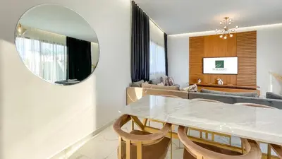 a dining room with a table and a mirror at Villa Alya with heated pool in Marrakesh in Marrakech