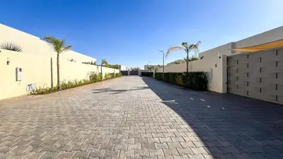 a cobblestone street in front of a building at Villa Alya with heated pool in Marrakesh in Marrakech