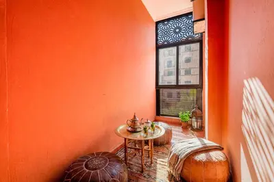 an orange room with a table and a window at Relaxing stay with pool & secure parking in Marrakech