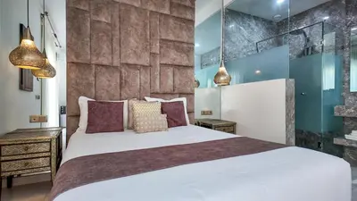 a bedroom with a large white bed with pillows at Aman Bungalow - heated pool, not overlooked in Marrakech