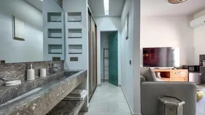 a bathroom with a large stone sink and a couch at Aman Bungalow - heated pool, not overlooked in Marrakech